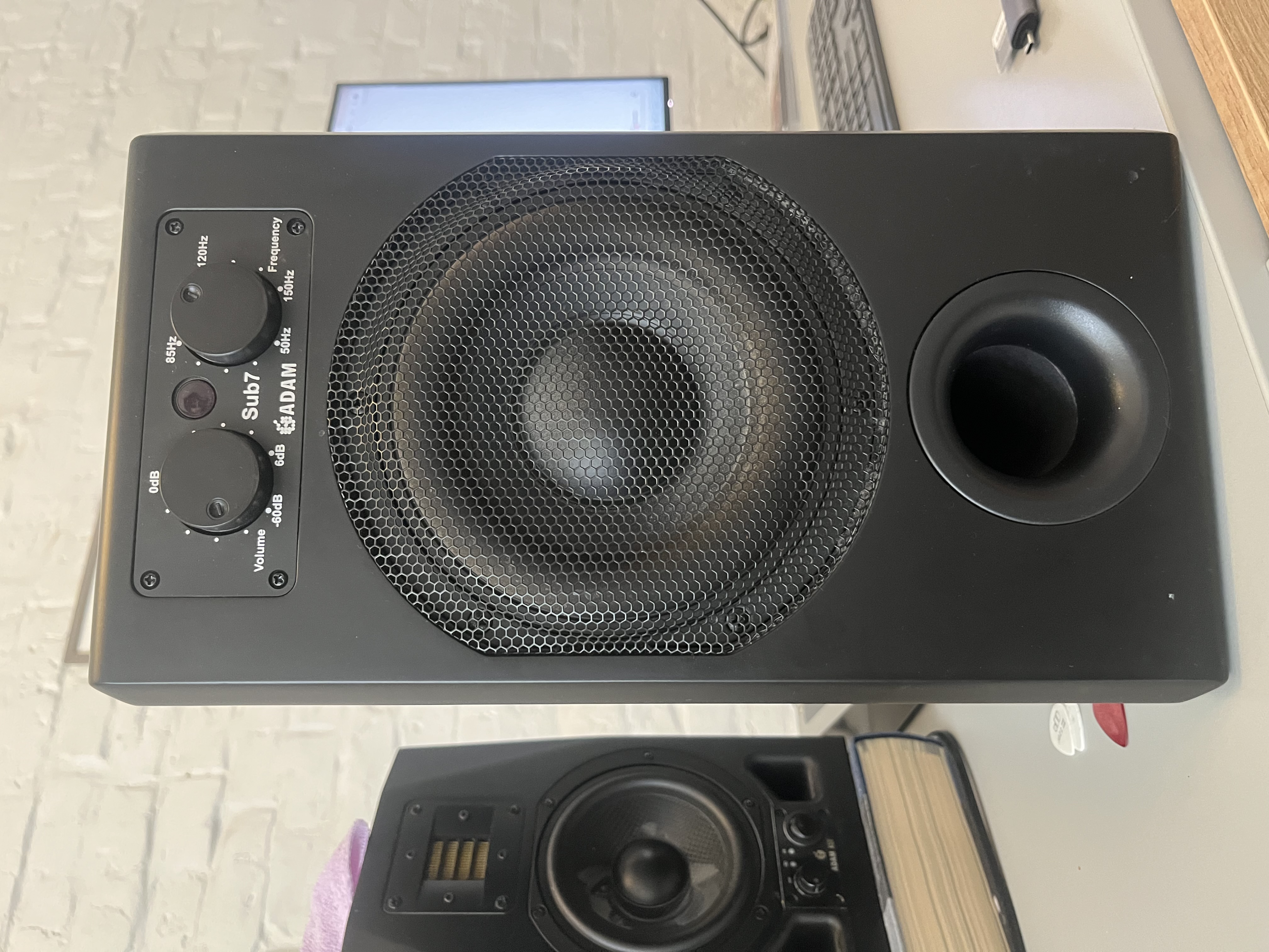 ADAM Sub7 subwoofer beside an ADAM nearfield monitor in a home studio.