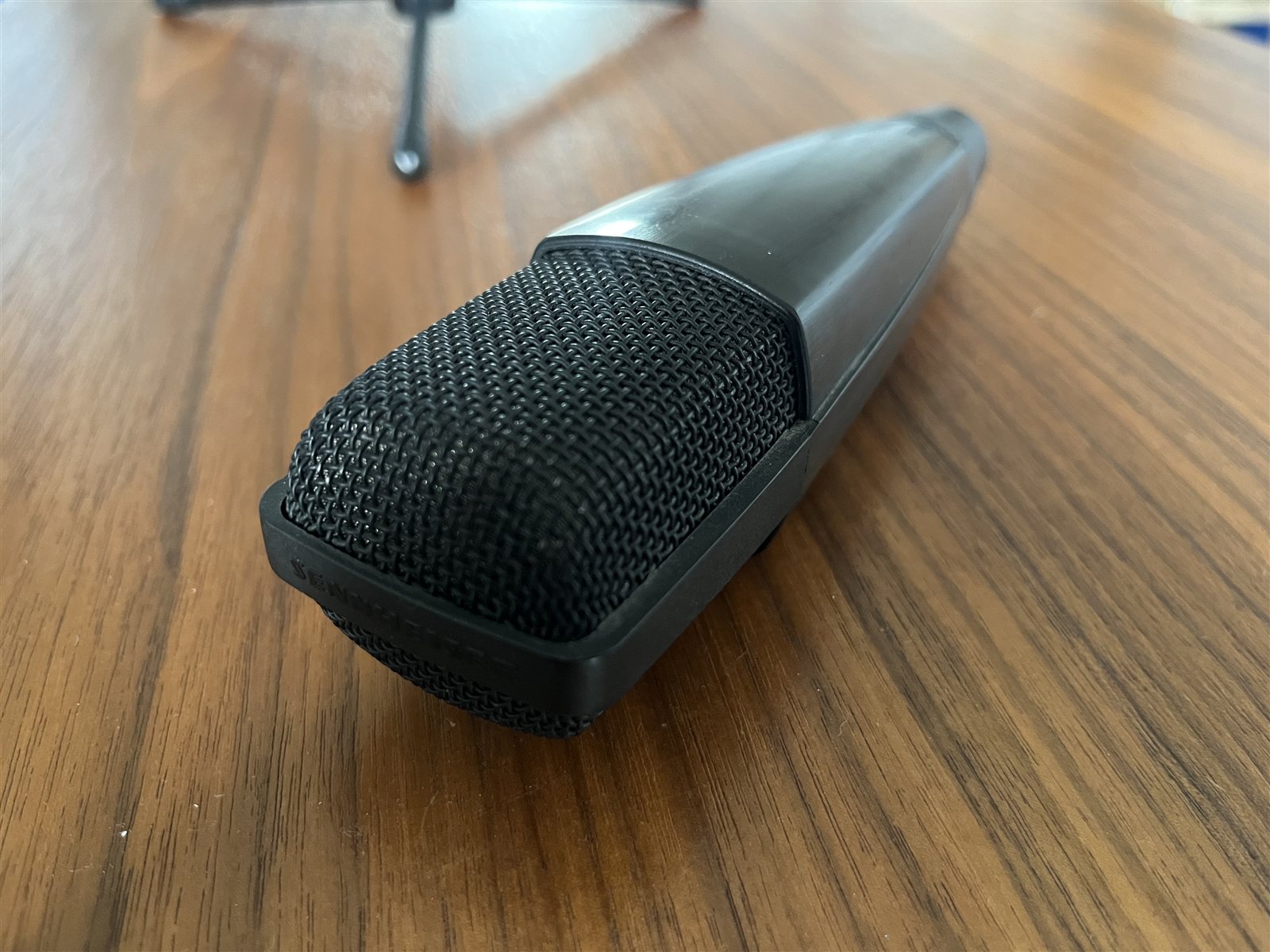 Studio microphone capsule photographed from the side.