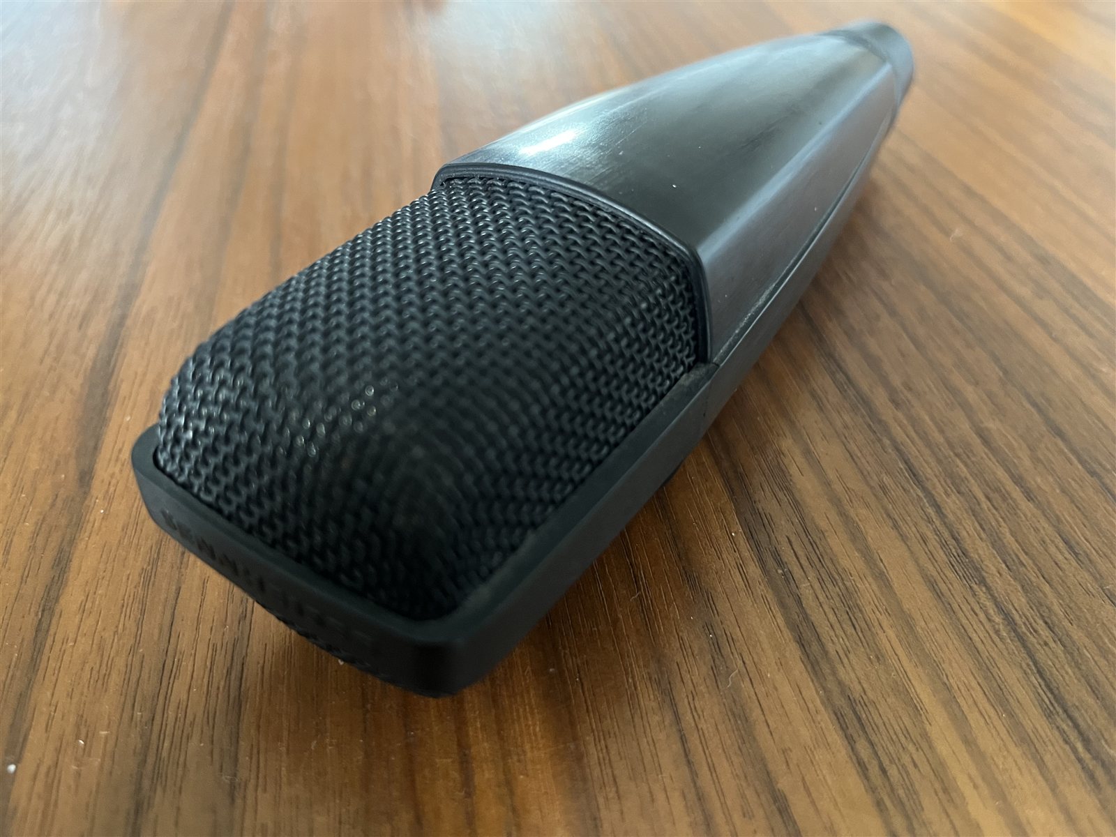 Side view of a microphone capsule in a home studio.