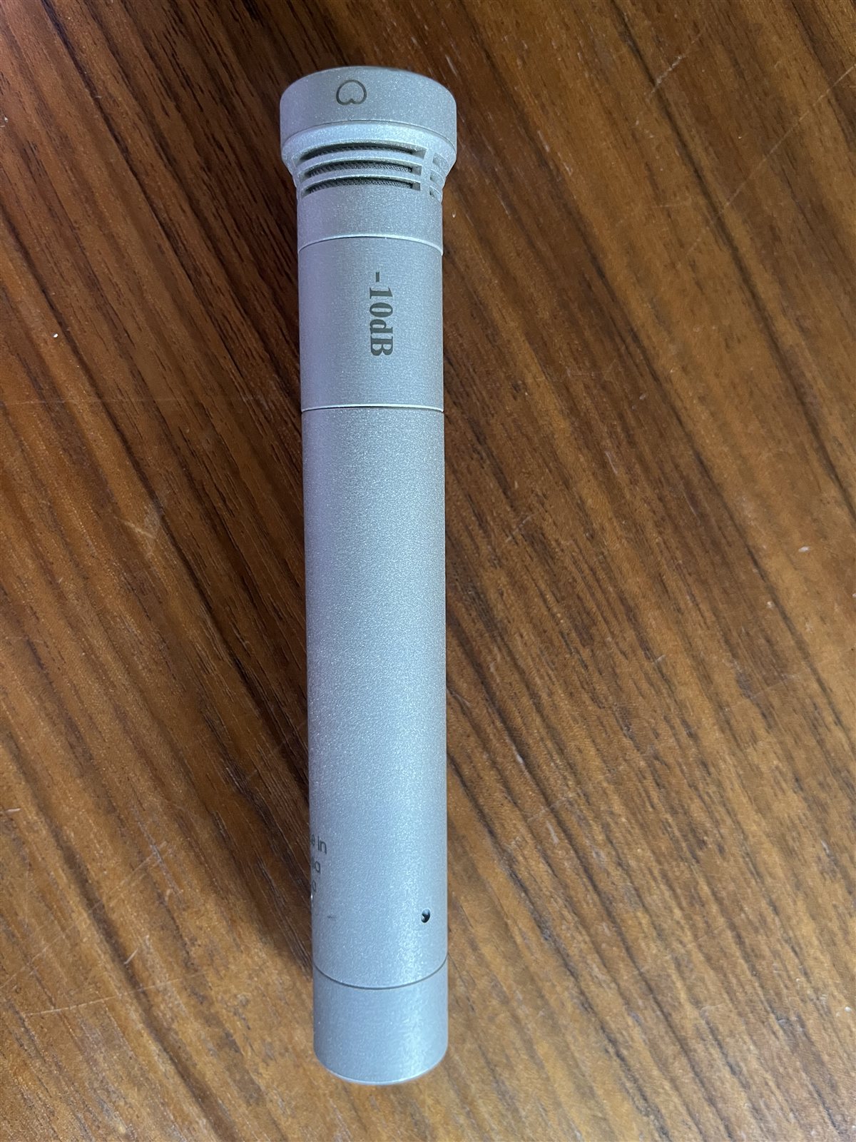 Oktava MK-012 small-diaphragm condenser microphone on a studio desk.