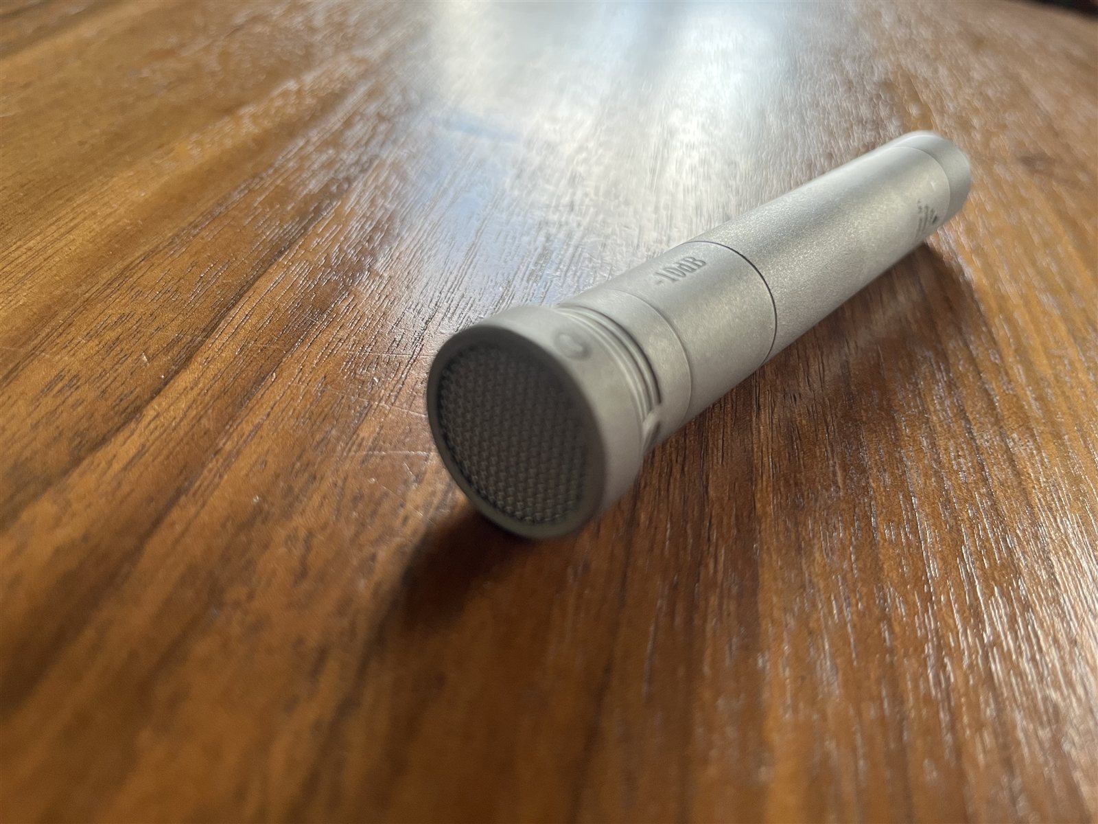 Oktava MK-012 small-diaphragm condenser microphone on a desk.