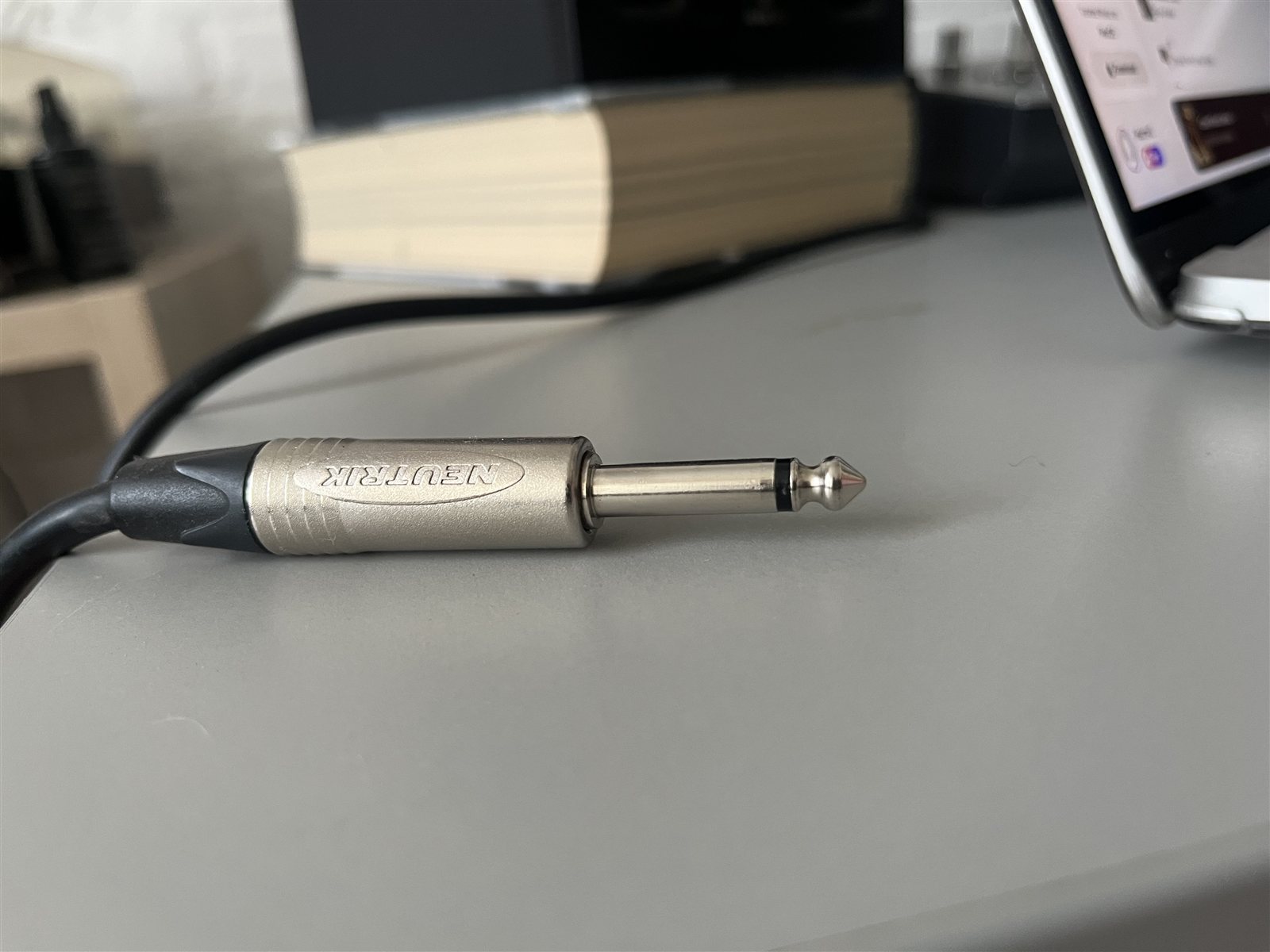 Quarter-inch line plug on a studio desk.